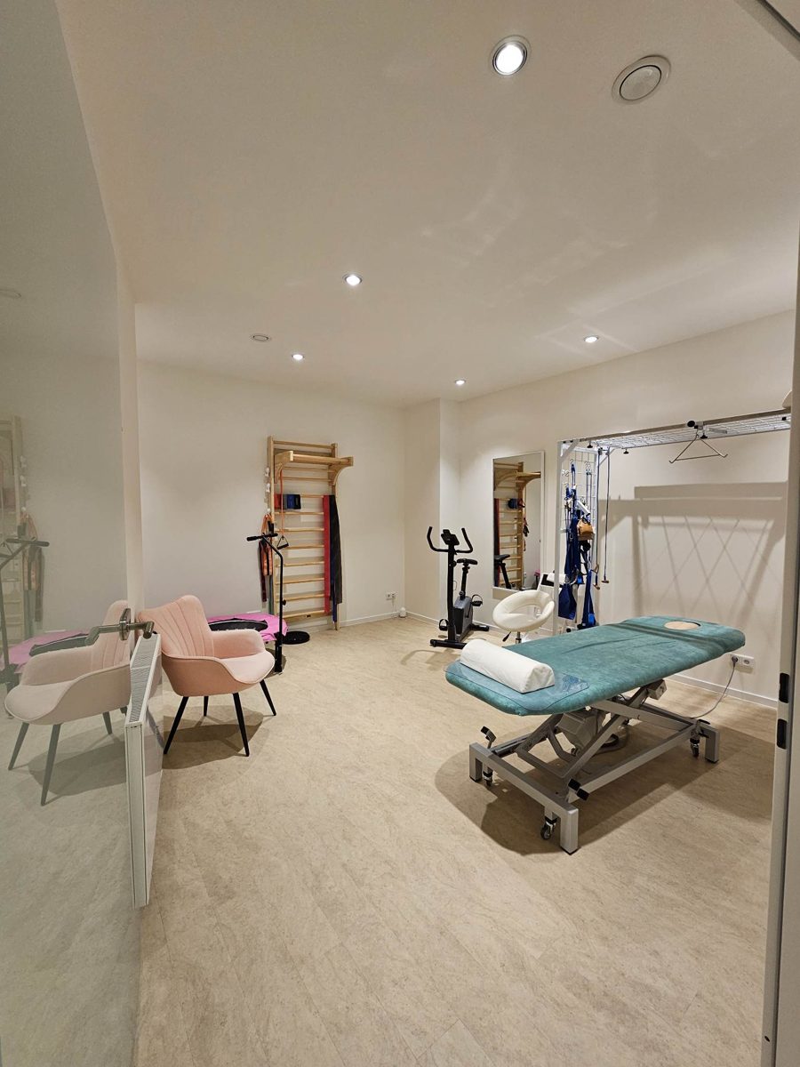 Therapieraum mit Behandlungsliege und Trainingsgeräten